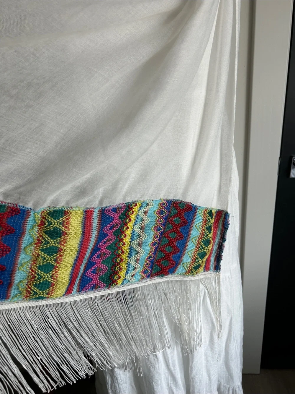 World Market white fringe scarf with red blue yellow green stitching